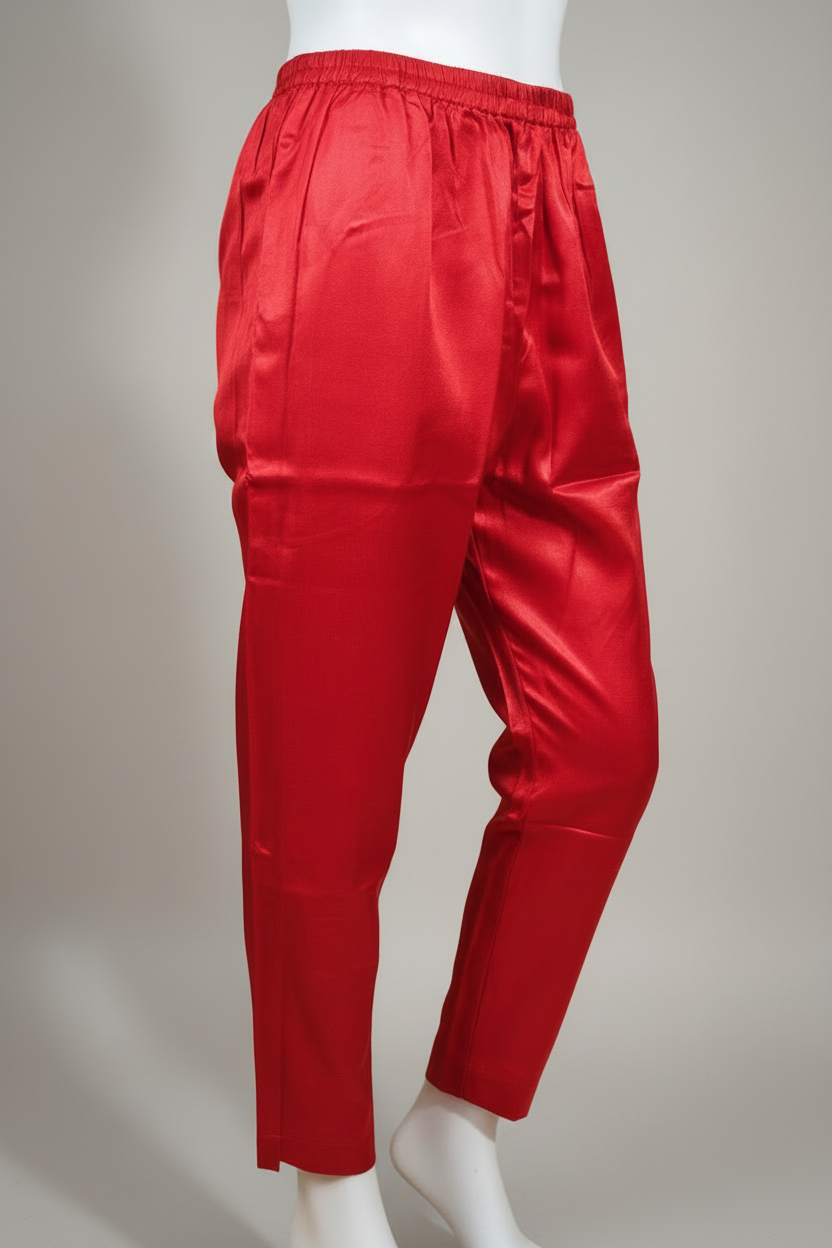 Red satin pants on a beige background